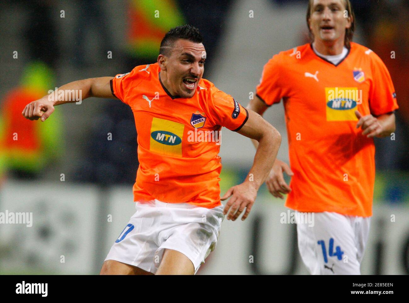 Apoel Nicosia's Constantinos Charalambides (L) celebrates his goal against  Porto with teammate Joost Broerse during their Champions League soccer  match at Dragon stadium in Porto October 21, 2009. REUTERS/Jose Manuel  Ribeiro (PORTUGAL