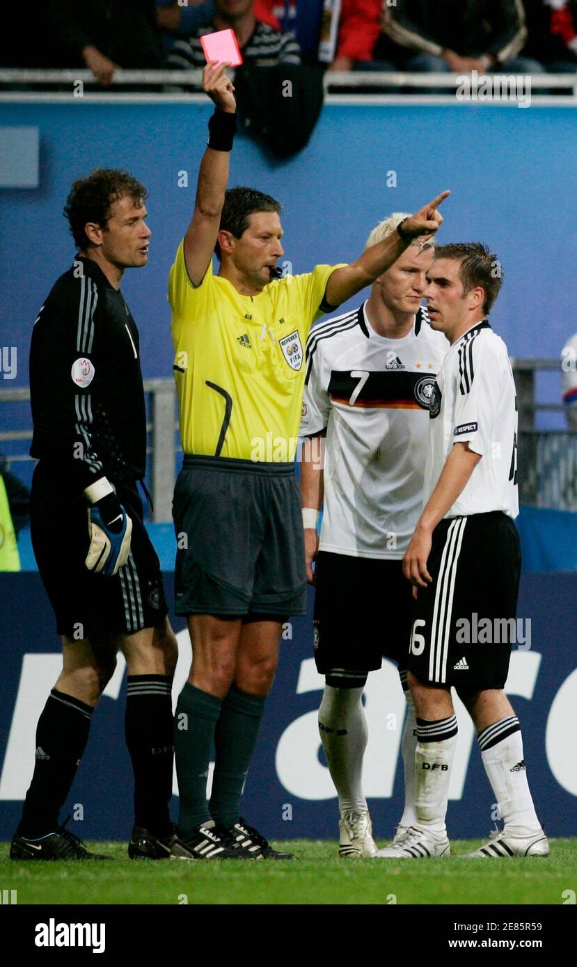 Match referee Frank De Bleeckere of Belgium (2ndL) shows a red card to  Germany's Bastian Schweinsteiger (3rdL) as his team mates Jens Lehmann (L)  and Philipp Lahm react during the Group B