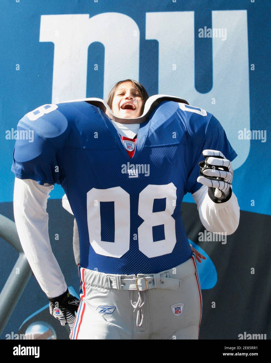 Glenda Ware, 9, poses in the suit of a New York Giants football player at the NFL Experience in Glendale, Arizona, January 30, 2008.       REUTERS/Rick Wilking    (UNITED STATES) Stock Photo