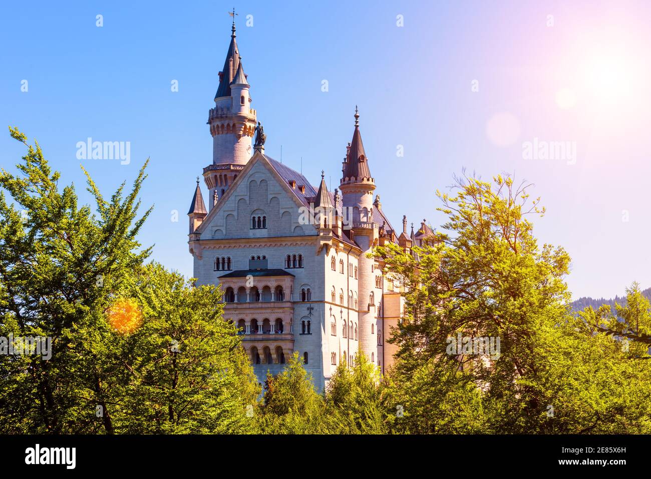 Neuschwanstein Castle in sunlight, Germany, Europe. Scenic sunny view of fairytale castle in Munich vicinity, famous tourist attraction of Bavarian Al Stock Photo