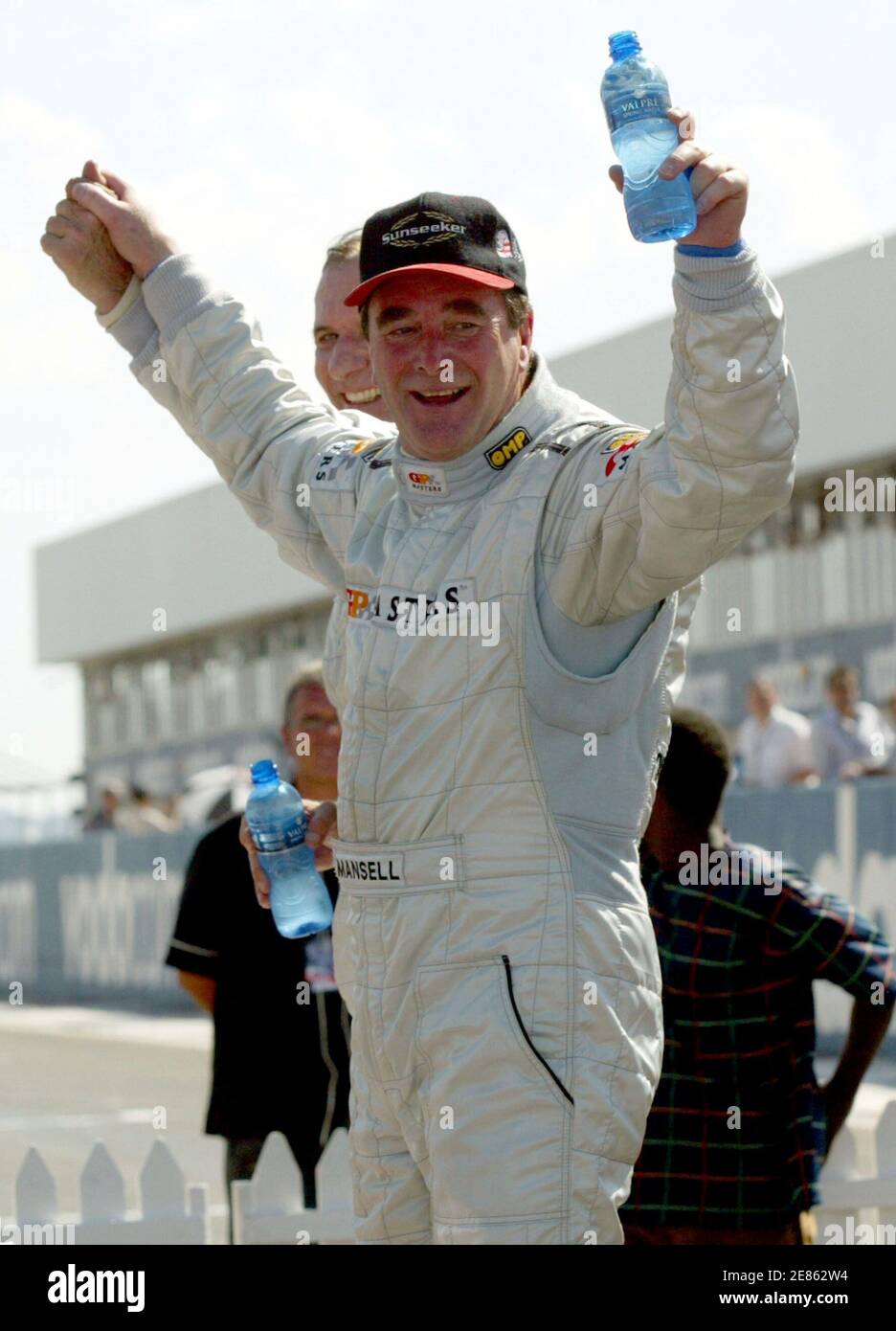 Britains Nigel Mansell celebrates after winning the Grand Prix Master at the Kyalami circuit near Johannesburg, November 13,2005. Mansell, 52, led the 30-lap race from start to finish and held off the challenge of Brazil's Emerson Fittipaldi to win by less than half-a-second. REUTERS Juda Ngwenya Stock Photo