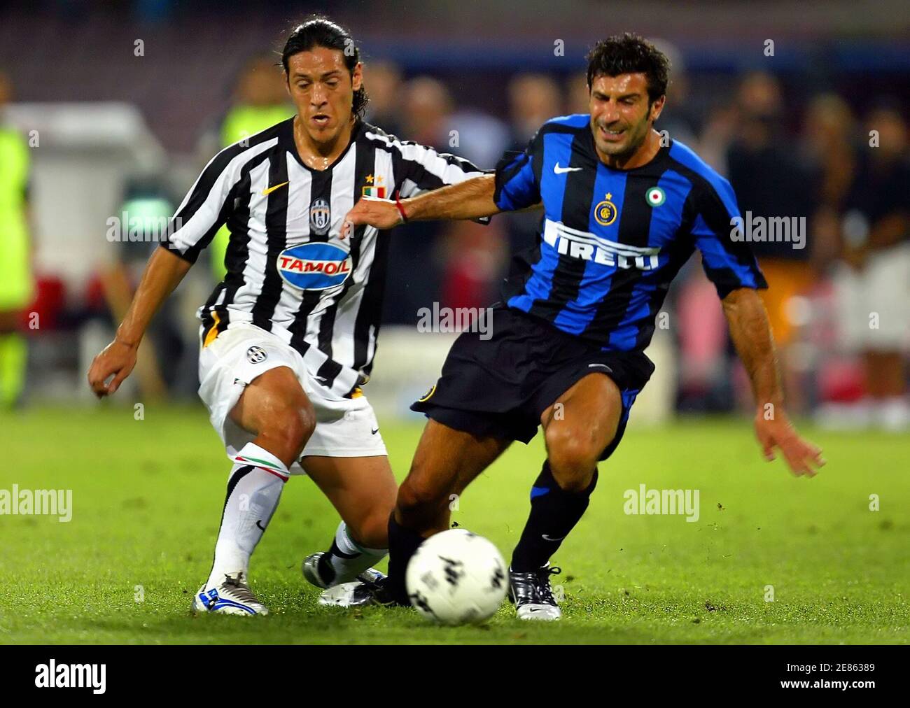 Juventus' Camoranesi and Inter Milan's Figo fight for the ball during the  Trophy Birra Moretti soccer match in Naples. Juventus' Mauro Camoranesi (L)  and Inter Milan's Luis Figo fight for the ball