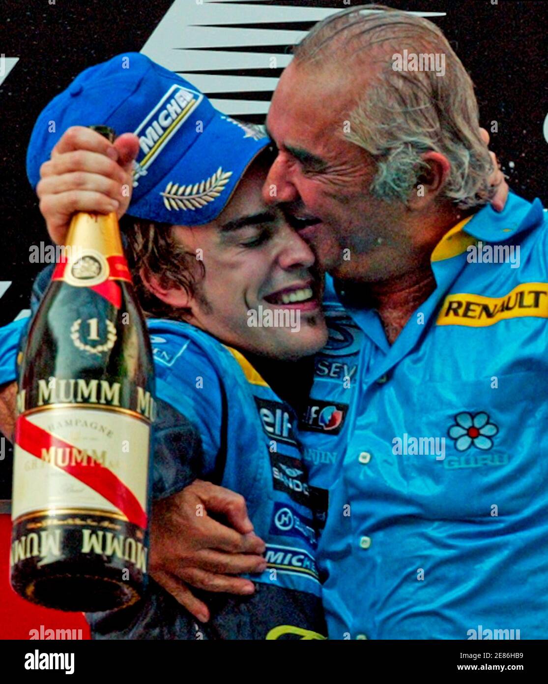 Renault's World Champion Formula One driver Fernando Alonso of Spain (L)  celebrates on the podium with Renault team managing director Flavio  Briatore after winning the Chinese Grand Prix in Shanghai October 16,