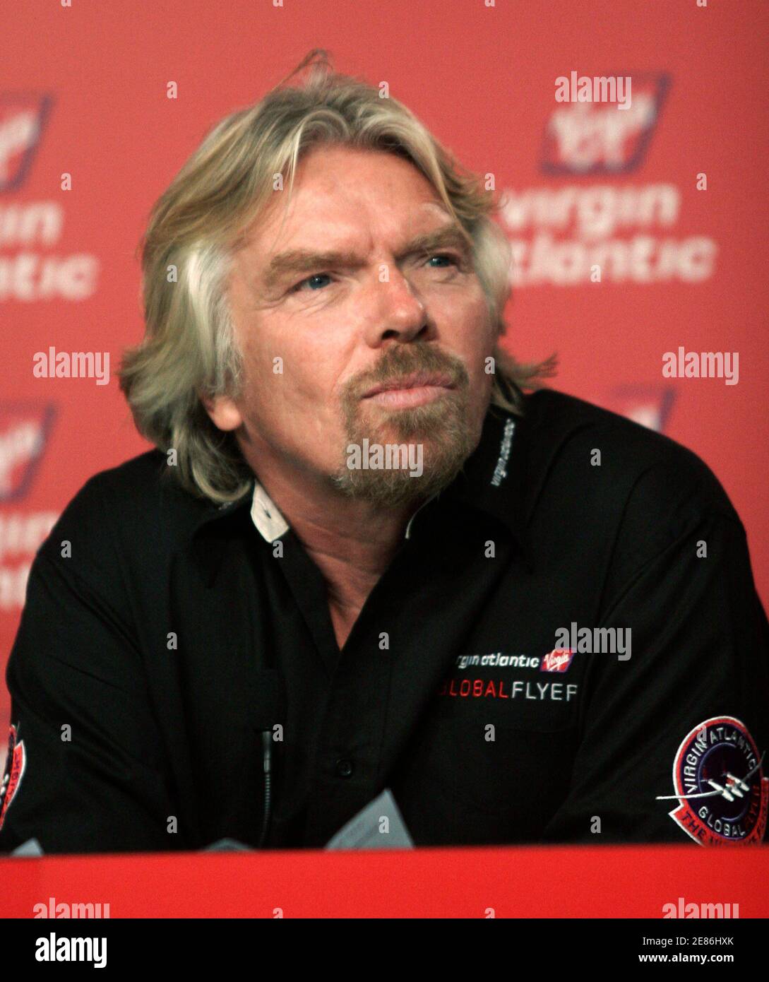 Sir Richard Branson, Chairman of the Virgin Group listens to question from reporters at the Kennedy Space Center in Cape Canaveral, Florida on February 6, 2006. Virgin Atlantic is sponsoring the GlobalfFlyer, an aircraft piloted by Steve Fossett, that will attempt a world record flight around the globe. Fossett hopes to cover a distance of 29,000 miles in around 90 hours. REUTERS/Rick Fowler Stock Photo