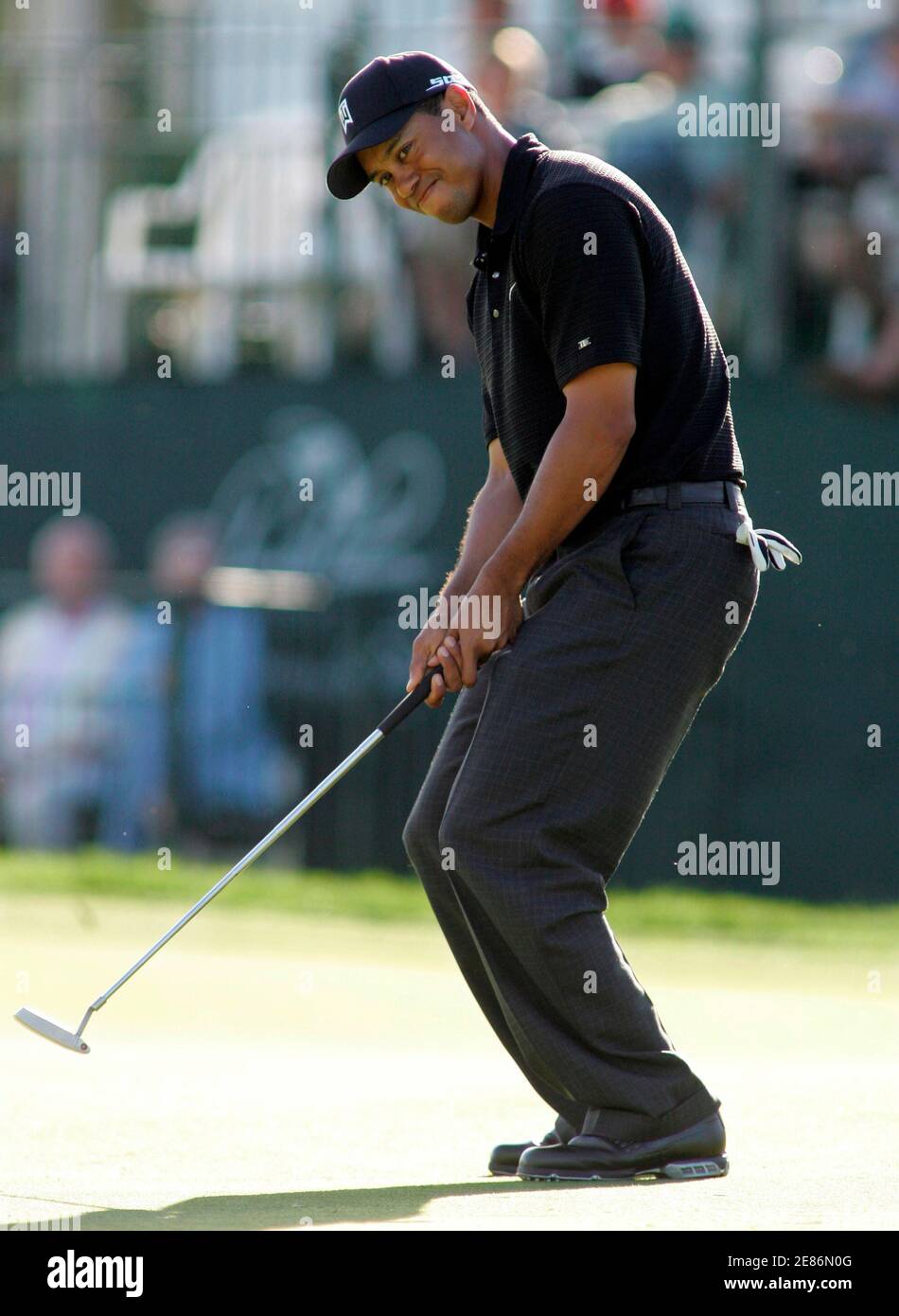 Tiger Woods reacts to a missed putt on the 17th hole during the second round of play at the Arnold Palmer Invitational golf tournament held at the Bay Hill Club in Orlando, Florida March 16, 2007. Woods finished the round at three-under-par with a score of 137. REUTERS/Rick Fowler (UNITED STATES) Stock Photo