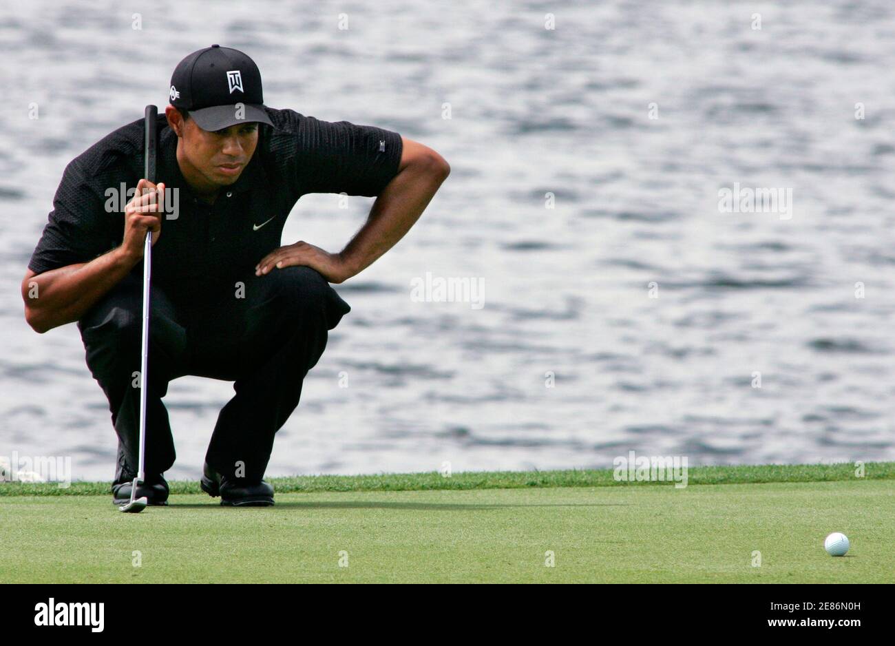 Tiger Woods lines up his putt on the third hole during the second round of play at the Arnold Palmer Invitational golf tournament held at the Bay Hill Club in Orlando, Florida, March 16, 2007. REUTERS/Rick Fowler (UNITED STATES) Stock Photo