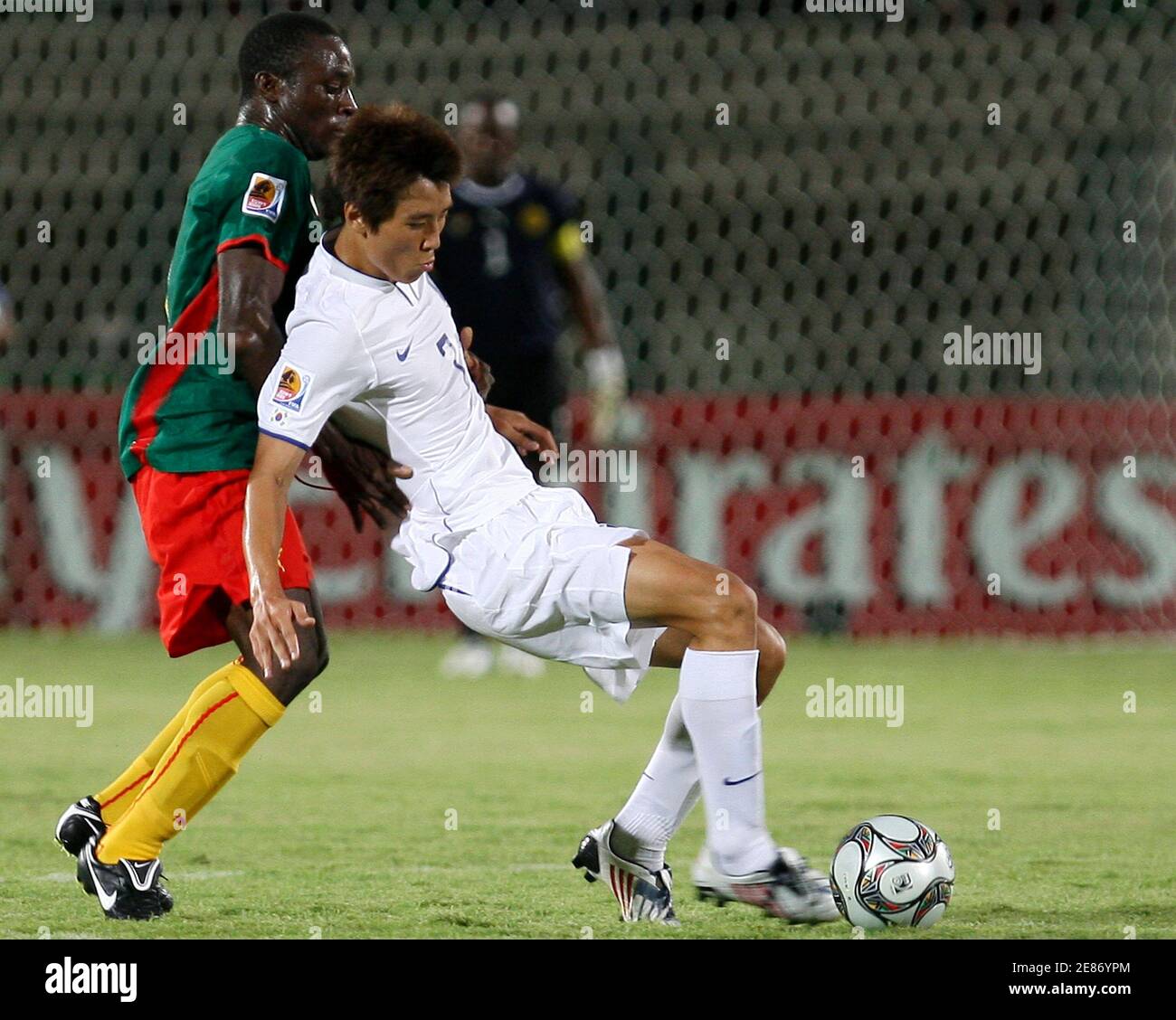 Enow Tabot of Cameroon (L) is challenged by Cheol Ja Koo of South Korea during their FIFA U-20 World Cup group C soccer match in Suez City September 26, 2009.   REUTERS/Amr Abdullah Dalsh (EGYPT SPORT SOCCER) Stock Photo