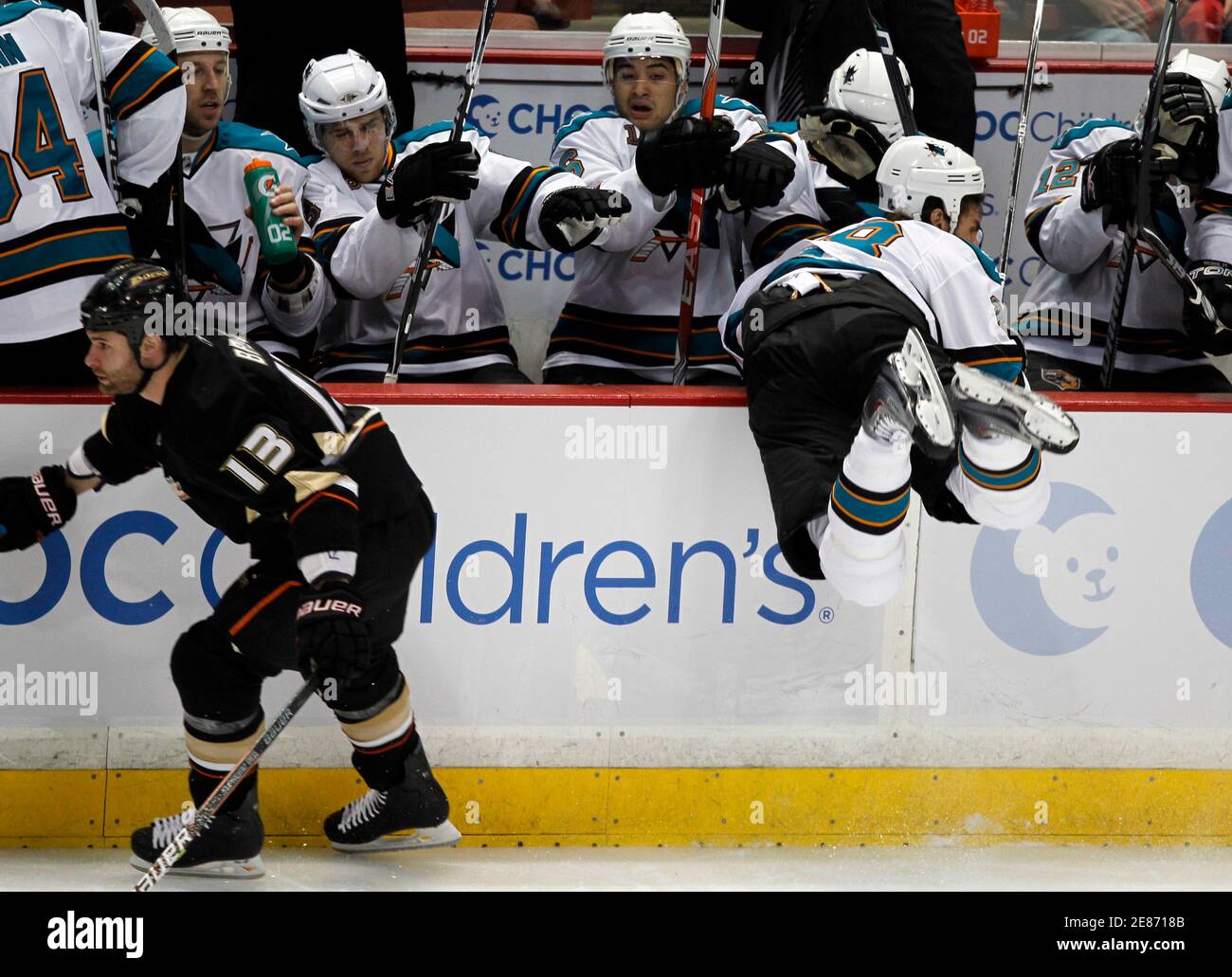 Anaheim Ducks right wing Mike Brown hits San Jose Sharks defenseman Jay Leach into the boards during the first period of their NHL hockey game in Anaheim, California March 14, 2010.  REUTERS/Mike Blake  (UNITED STATES - Tags: SPORT ICE HOCKEY) Stock Photo