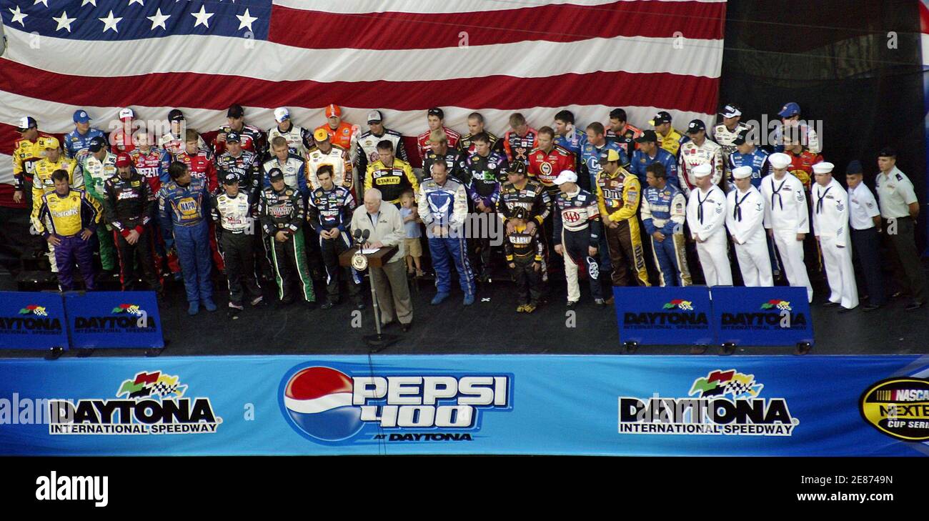 Vice President Dick Cheney addresses the crowd with the pack 43 NASCAR drivers behind him prior to the start of the Pepsi 400 at the Daytona International Speedway in Daytona Beach, Florida on July 1, 2006. REUTERS/Rick Fowler (United States) Stock Photo