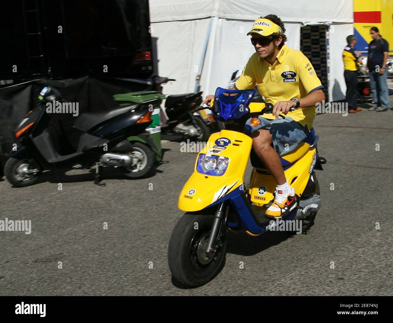 Yamaha motoGP rider Valentino Rossi of Italy rides a scooter after  finishing the third free practice session of the Portugese Grand Prix in  Estoril October 14, 2006. REUTERS/Marcelo del Pozo (PORTUGAL Stock