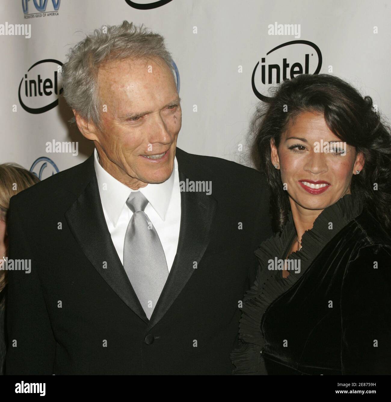 Actor, producer and director Clint Eastwood (L) and wife Dina Ruiz pose as they arrive at the 2006 Producers Guild Awards in Los Angeles, California January 22, 2006. Eastwood is to receive The Milestone Award at the ceremony. Stock Photo