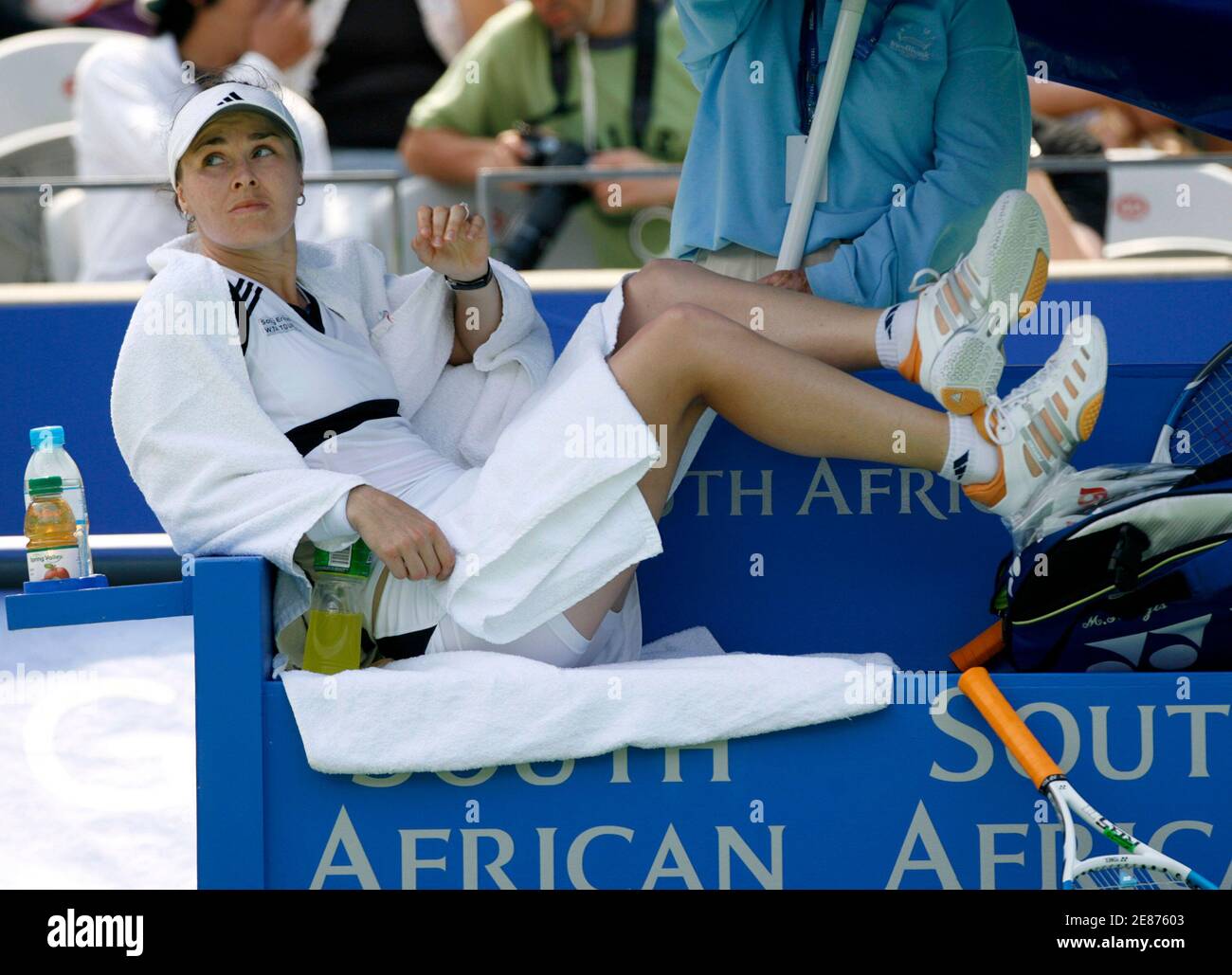 Martina Hingis of Switzerland lies on a seat while Jelena Jankovic (not  shown) of Serbia receives a medical time-out during their first round match  at the Sydney International Tennis Tournament at Olympic