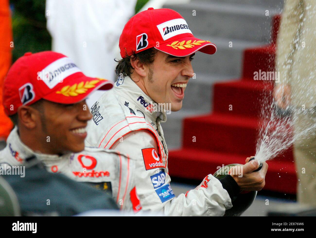 McLaren Formula One drivers Fernando Alonso (R) of Spain and Lewis Hamilton  (L) of Britain spray champagne after placing first and second in the Monaco  F1 Grand Prix in Monte Carlo May