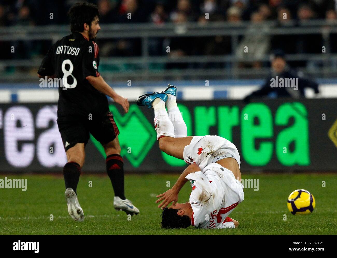 Bari's Emanuel Benito Rivas (R) flies down as Gennaro Gattuso (C) of AC Milan passes near during their Serie A soccer match at the San Nicola stadium in Bari February 21, 2010. REUTERS/Alessandro Bianchi (ITALY - Tags: SPORT SOCCER) Stock Photo