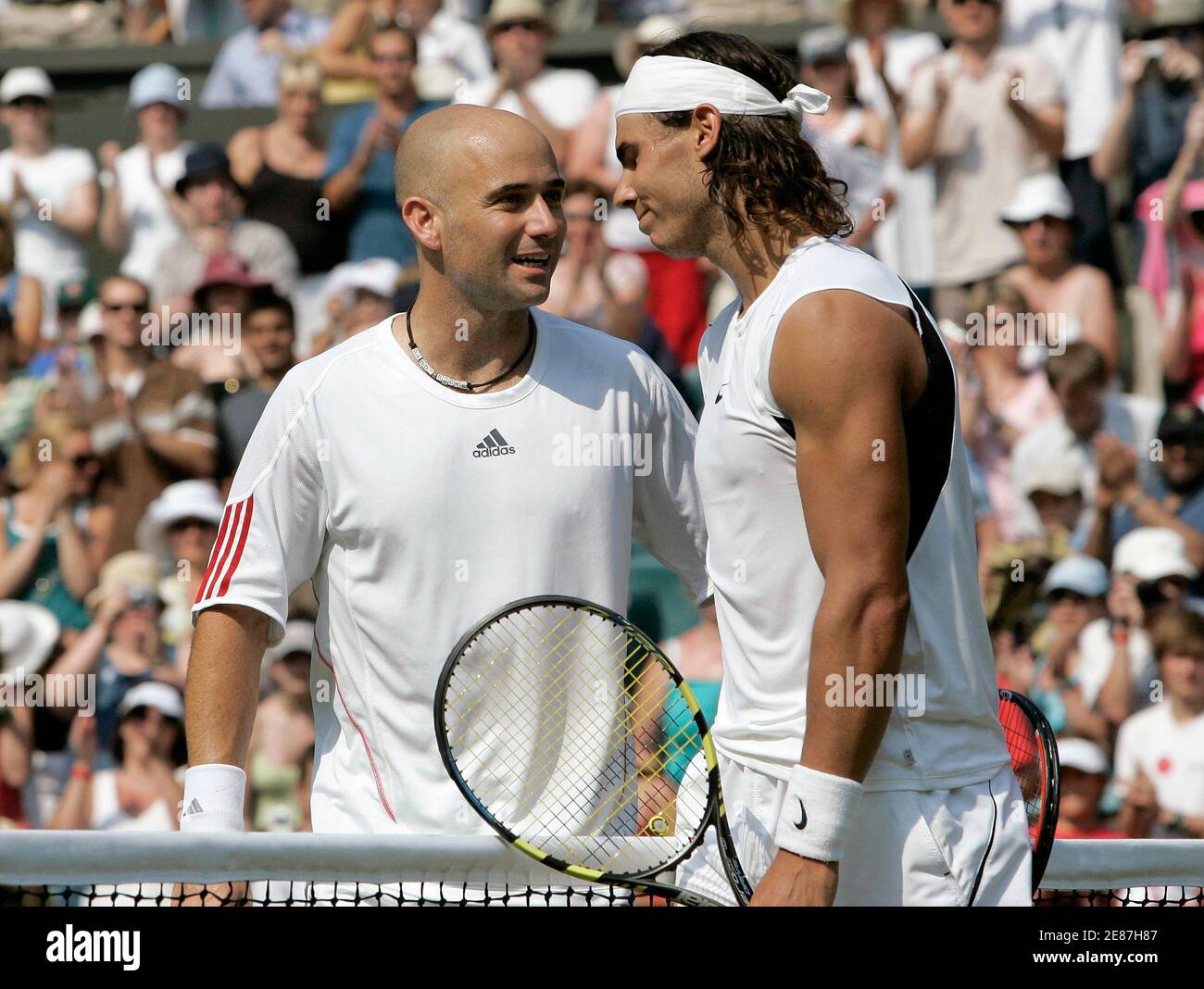 Andre Agassi of the U.S. (L) talks with Spain's Rafael Nadal after being  defeated during their match at the Wimbledon tennis championships in London  July 1, 2006, which was Agassi's last Wimbledon