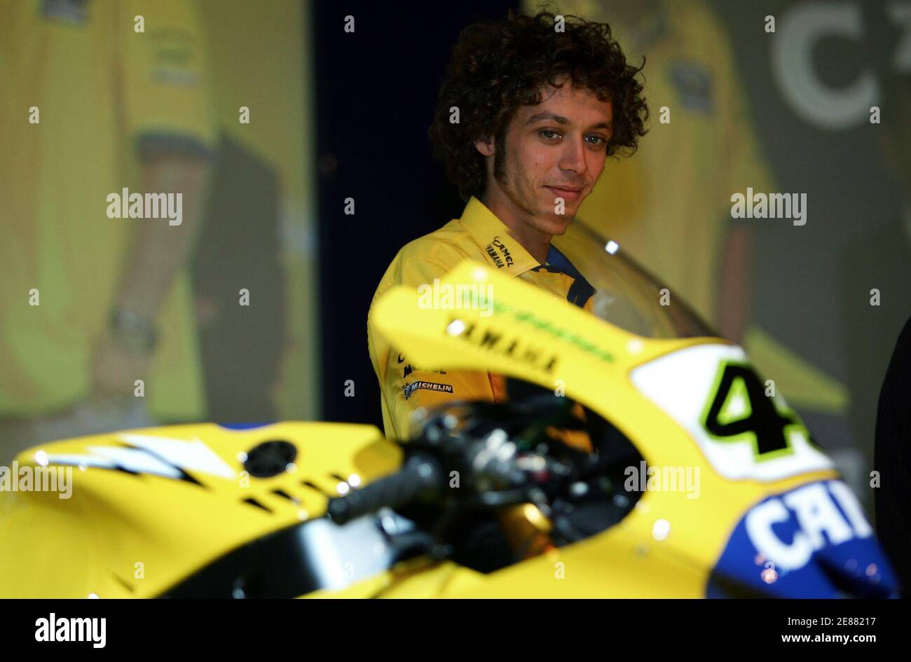 MotoGP world champion Valentino Rossi of Italy looks at his new Yamaha  during a news conference in Milan February 27, 2006. REUTERS/Daniele La  Monaca Stock Photo - Alamy