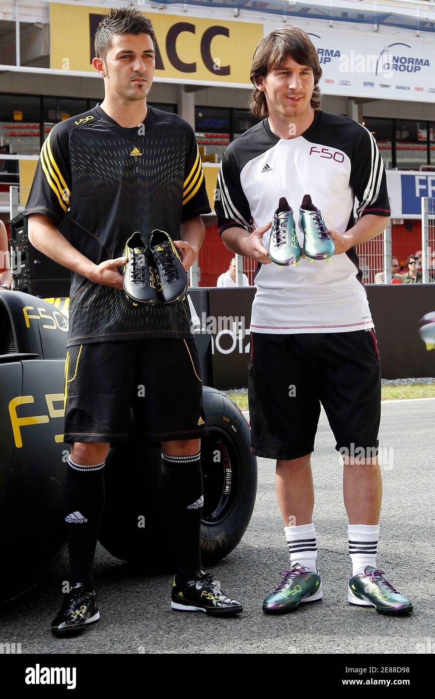 Argentina's national soccer team player Lionel Messi (R) and Spanish  national team player David Villa display the new F50 adiZero soccer boots  during a promotional event at Montmelo circuit near Barcelona May