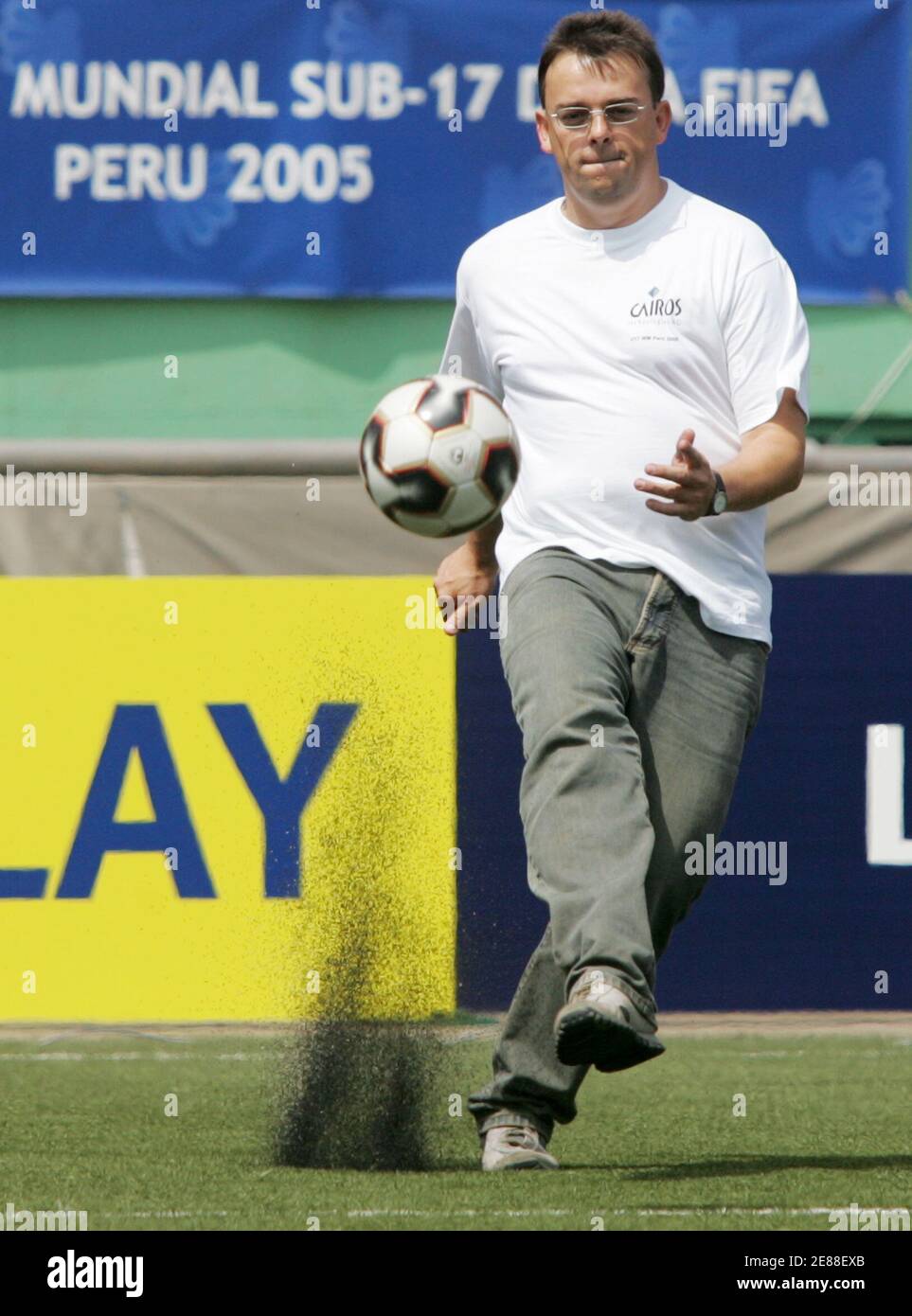 An engineer of German Cairos Technologies shoots an Adidas Pelias 2 soccer  ball with a micro-chip inside during a test at National Stadium in Lima,  September 13, 2005. FIFA will experiment with