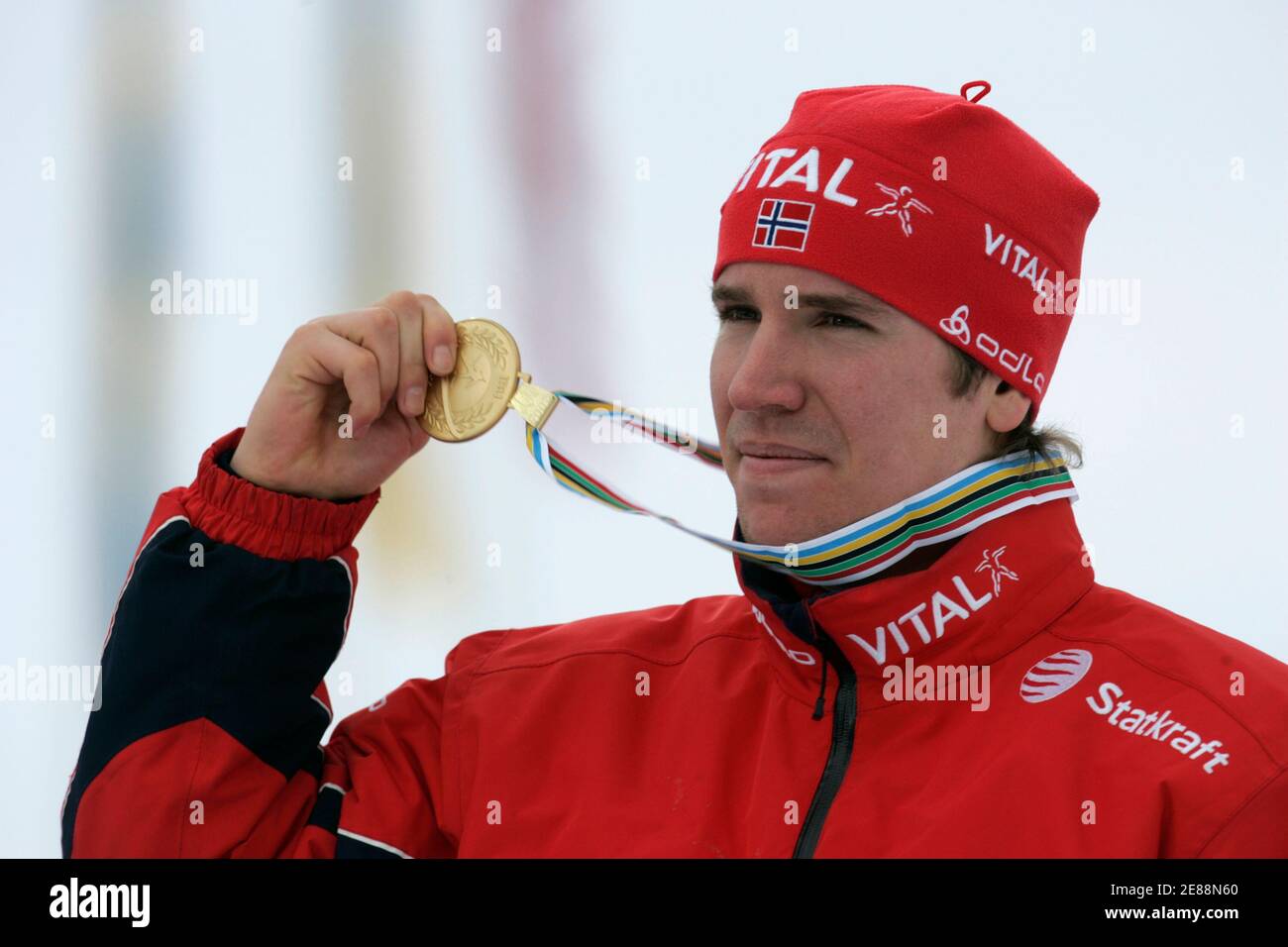 Norway's Emil Hegle Svendsen shows his gold medal after winning the men's 15 km mass start