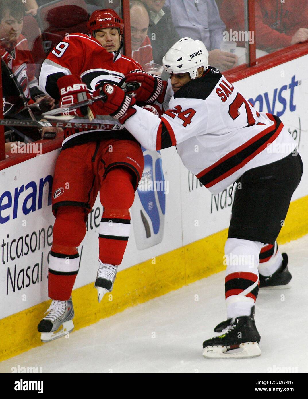New Jersey Devils' Bryce Salvador checks the Carolina Hurricanes' Chad  LaRose during their NHL hockey game in Raleigh, North Carolina March 18,  2009. REUTERS/Ellen Ozier (UNITED STATES SPORT ICE HOCKEY Stock Photo -
