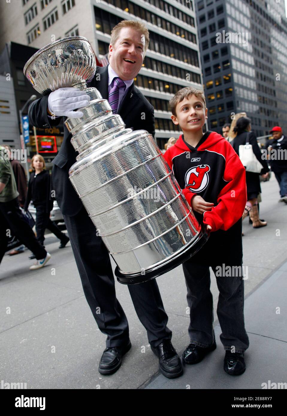 mike-bolt-the-national-hockey-league-s-keeper-of-the-cup-shows-the-stanley-cup-trophy-to-fan-alec-baxter-on-6th-avenue-in-new-york-april-15-2009-the-quest-for-the