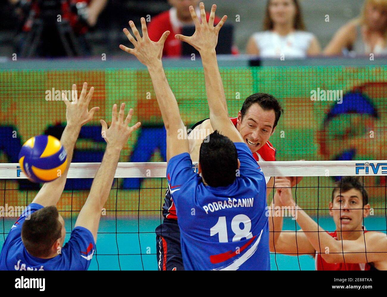David Lee of the U.S. spikes the ball against Serbia's Bojan Janic (L) and Marko Podrascanin during their men's World League 2009 final round volleyball match in Belgrade July 22, 2009.  REUTERS/Ivan Milutinovic (SERBIA SPORT VOLLEYBALL) Stock Photo