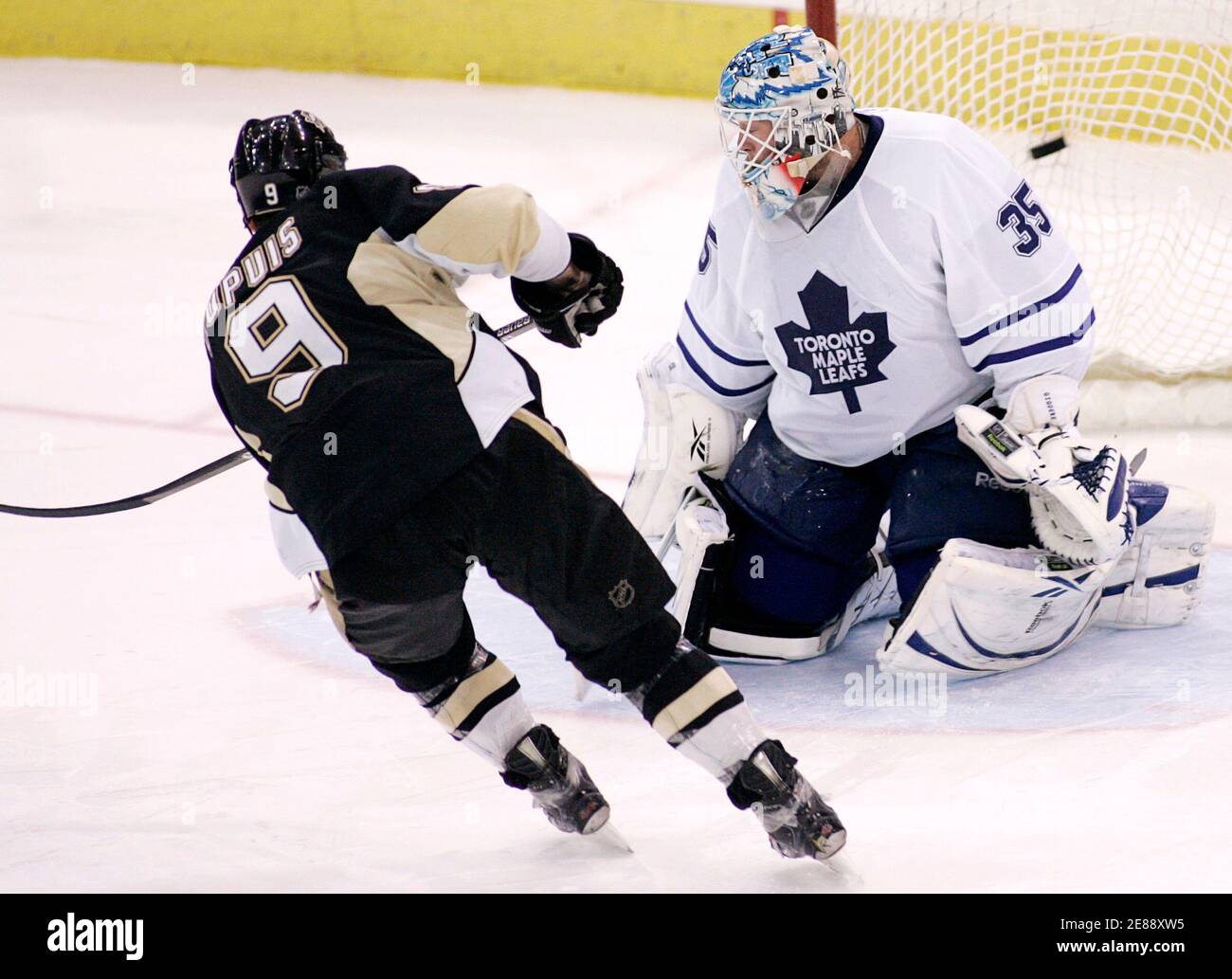 Pittsburgh Penguins Pascal Dupuis (9) scores against Toronto Maple Leafs  goalie Jean-Sebastien Giguere in a shootout at their NHL hockey game in  Pittsburgh, Pennsylvania, March 28, 2010. REUTERS/ Jason Cohn (UNITED  STATES -