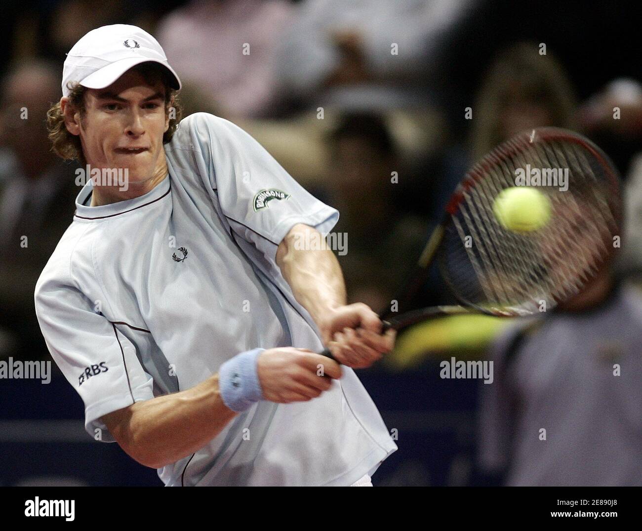 Britain's Andy Murray returns a backhand to his compatriot Tim Henman  during their first round match