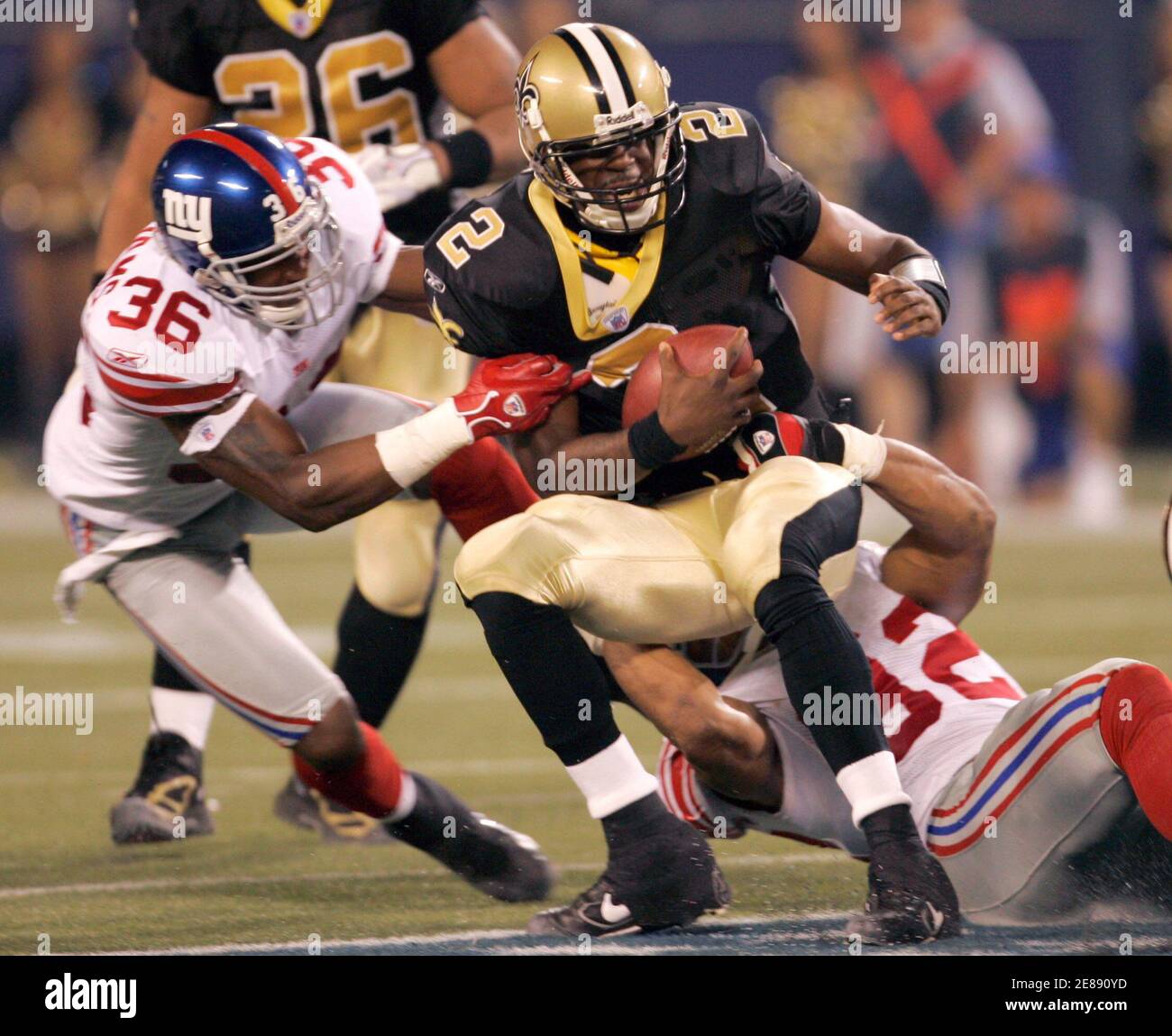 New Orleans Saints quarterback Aaron Brooks is sacked by New York Giants  Shaun Williams and Michael Strahan during second quarter action. New  Orleans Saints quarterback Aaron Brooks (2) is sacked by New