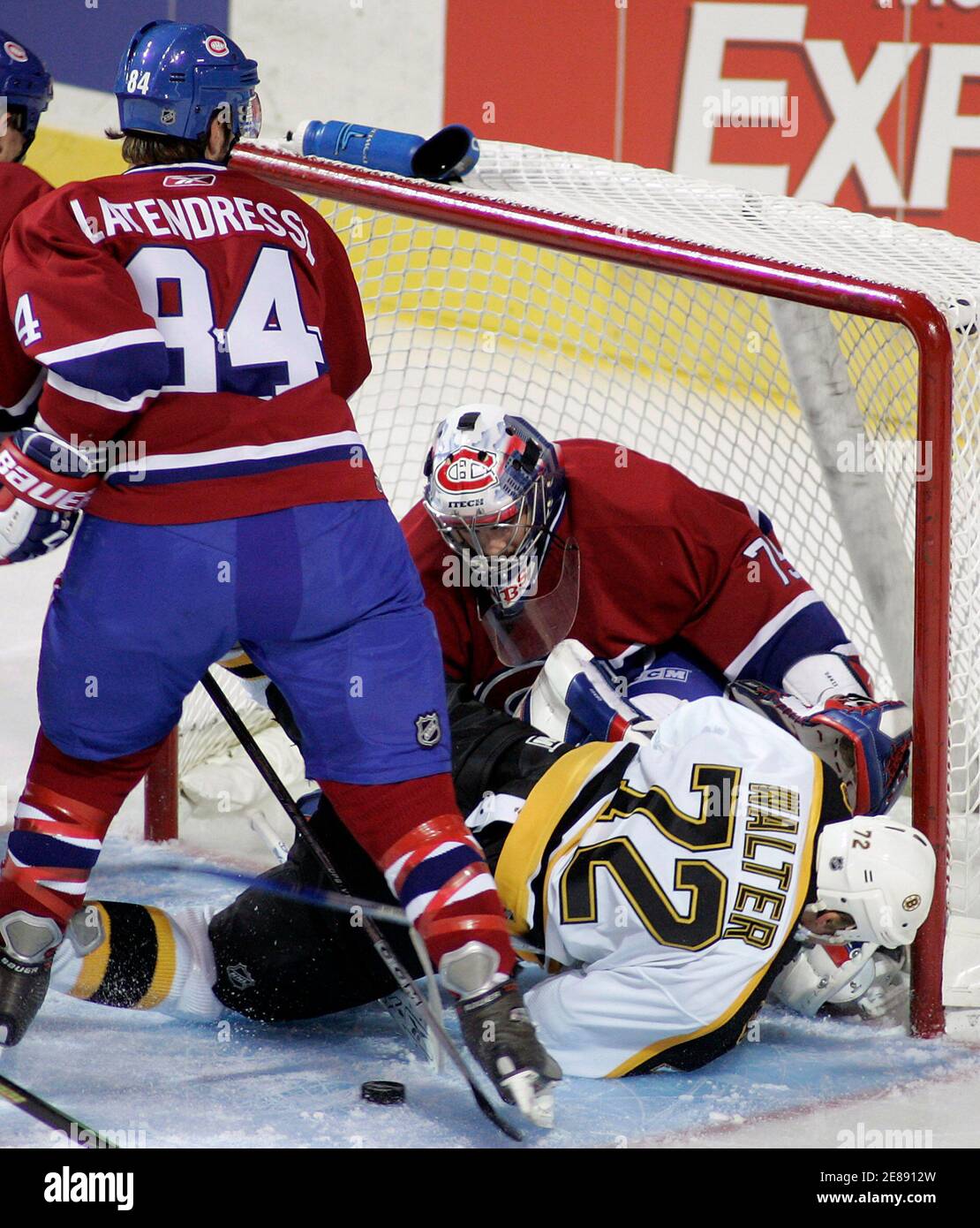 Montreal Canadiens Guillaume Latendresse 84 Looks On As Ben Walter Of The Boston Bruins 72 Slides Into Montreal Canadiens Goaltender Yann Danis As He Makes The Save During First Period Pre Season Nhl