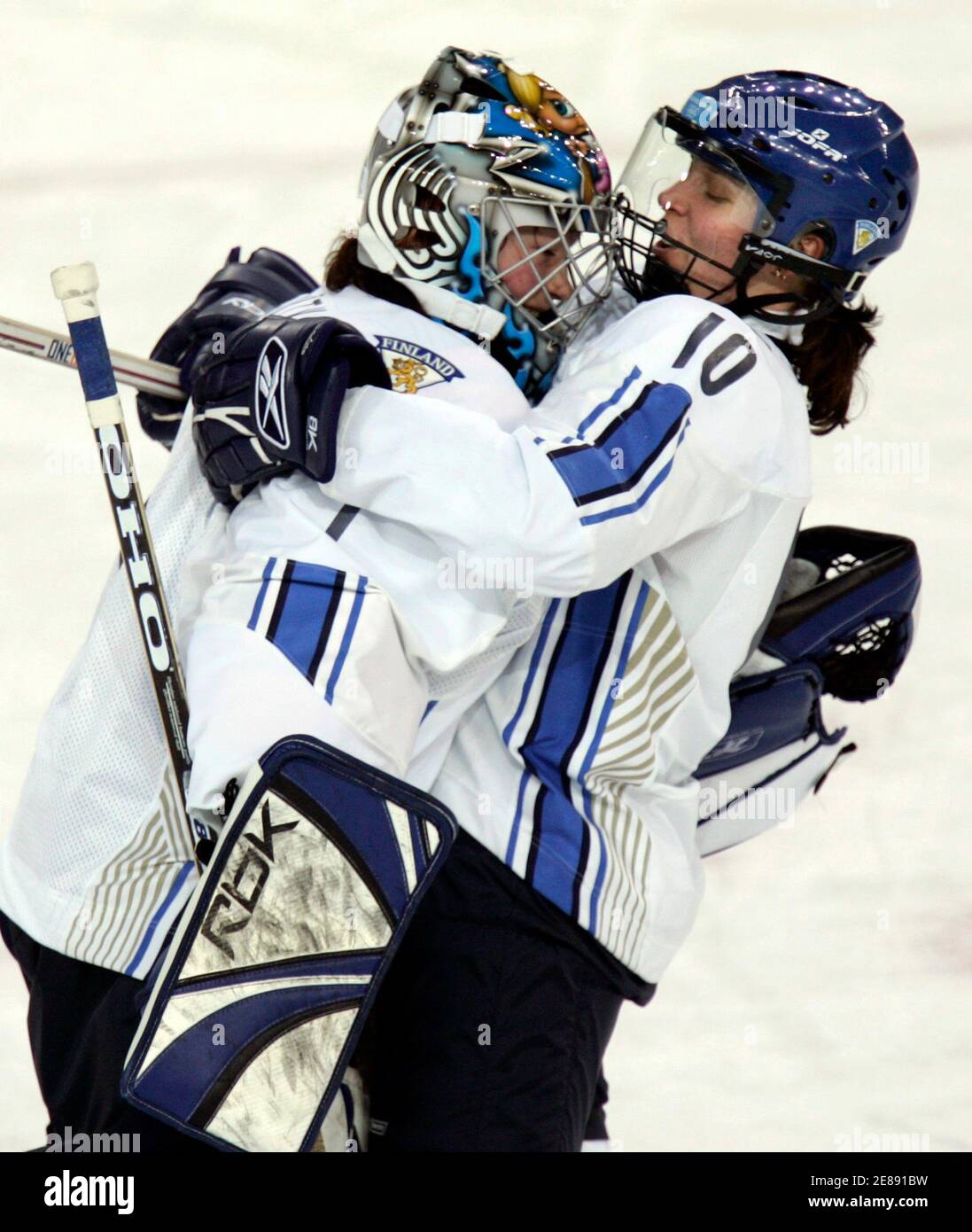 Finland's goalie Noora Raty (L) celebrates their win over Switzerland with  teammate Sari Fisk after their women's ice hockey game at the Torino 2006  Winter Olympic Games in Turin, Italy February 13,