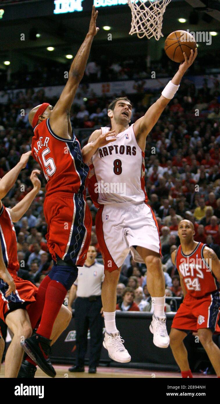 Toronto Raptors Jose Calderon (R) puts up a shot against New Jersey Nets'  Vince Carter during the first half of Game 5 of their NBA Eastern  Conference Playoff basketball series in Toronto,