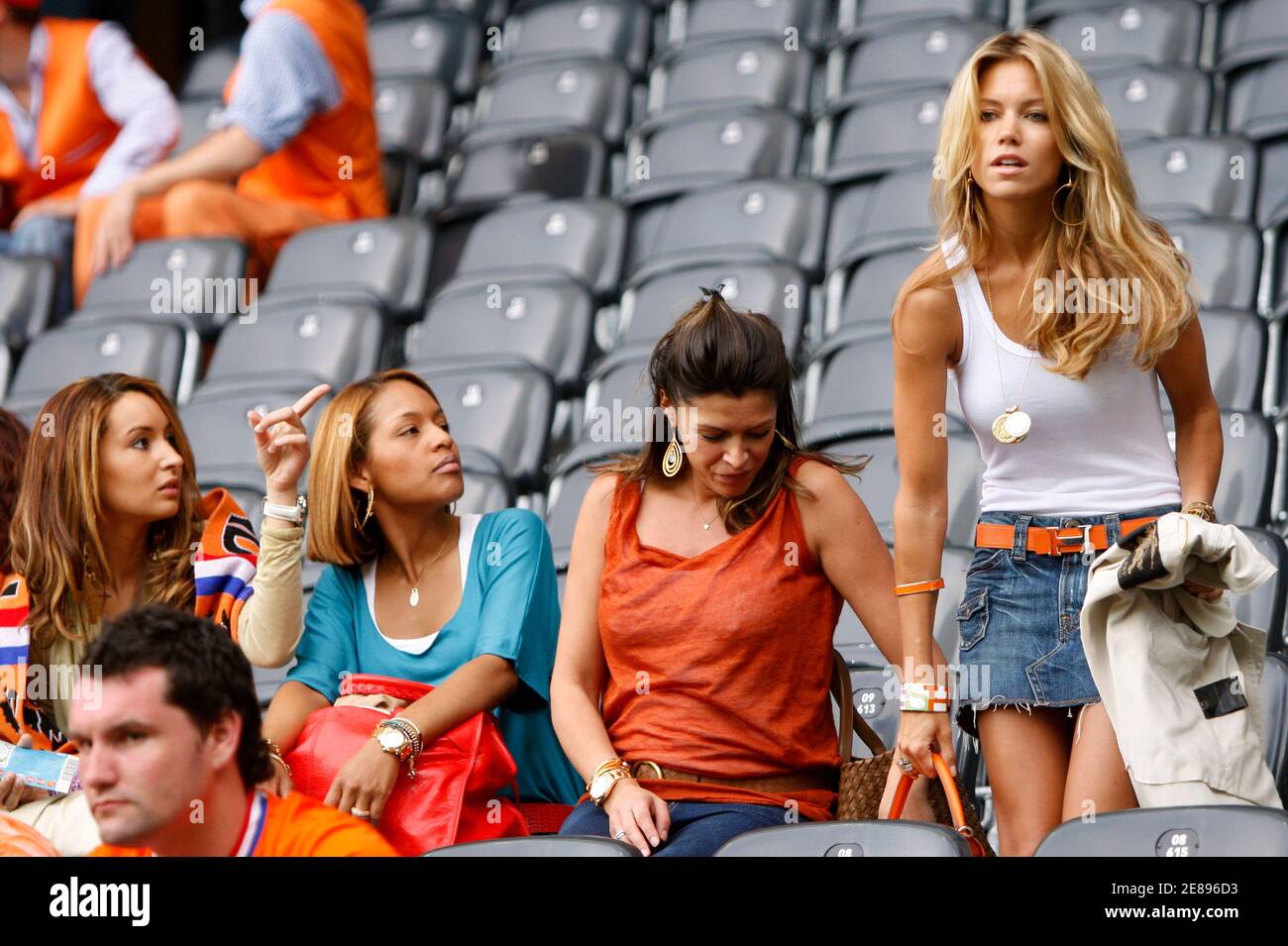 Sylvie Van der Vaart (R), wife of Netherlands' Rafael Van der Vaart, takes a seat beside Sabia Boulahrouz wife of Khalid Boulahrouz in the stands before their Group C Euro 2008 soccer match against Italy at the Stade de Suisse Stadium in Bern June 9, 2008. REUTERS/Michael Kooren (SWITZERLAND) MOBILE OUT. EDITORIAL USE ONLY Stock Photo
