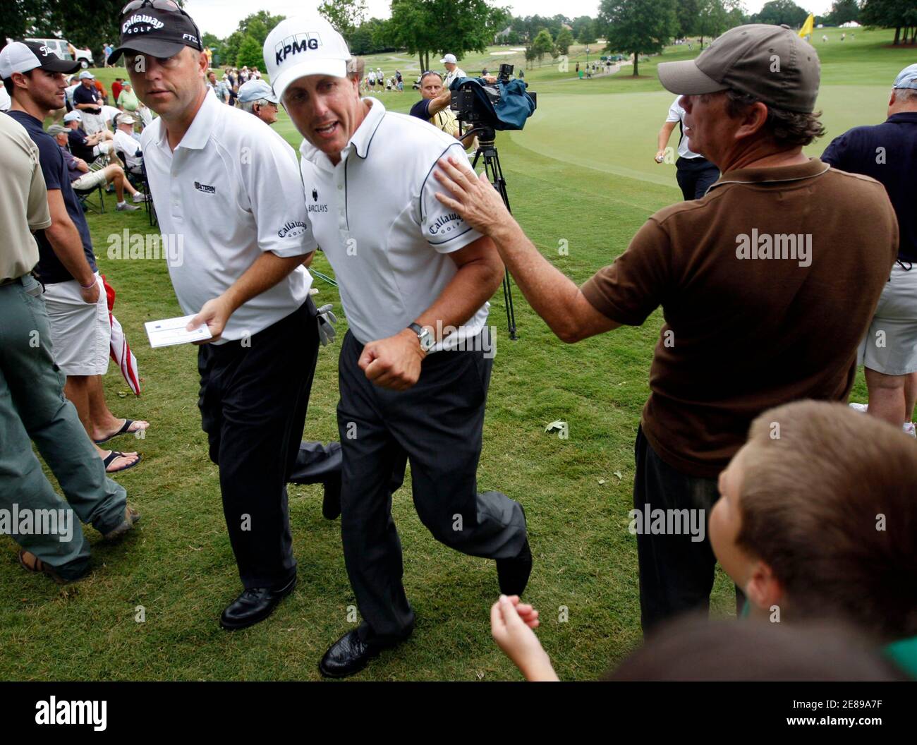 Cameron Beckman (L), of the U.S., and Phil Mickelson (C), of the U.S., walk off the 17th green during the first round of the St. Jude Classic at TPC Southwind in Memphis, Tennessee June 11, 2009.   REUTERS/Nikki Boertman    (UNITED STATES SPORT GOLF) Stock Photo