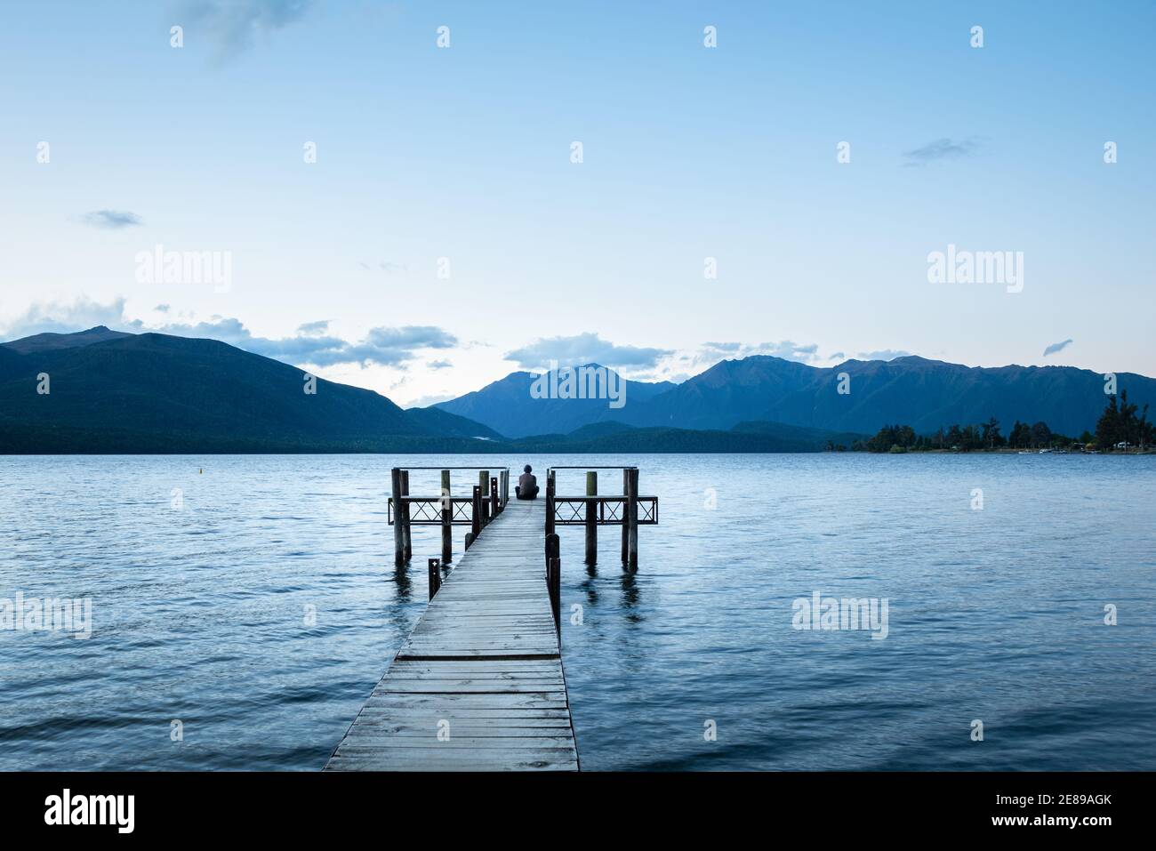 Man sitting jetty looking lake hi-res stock photography and images - Alamy