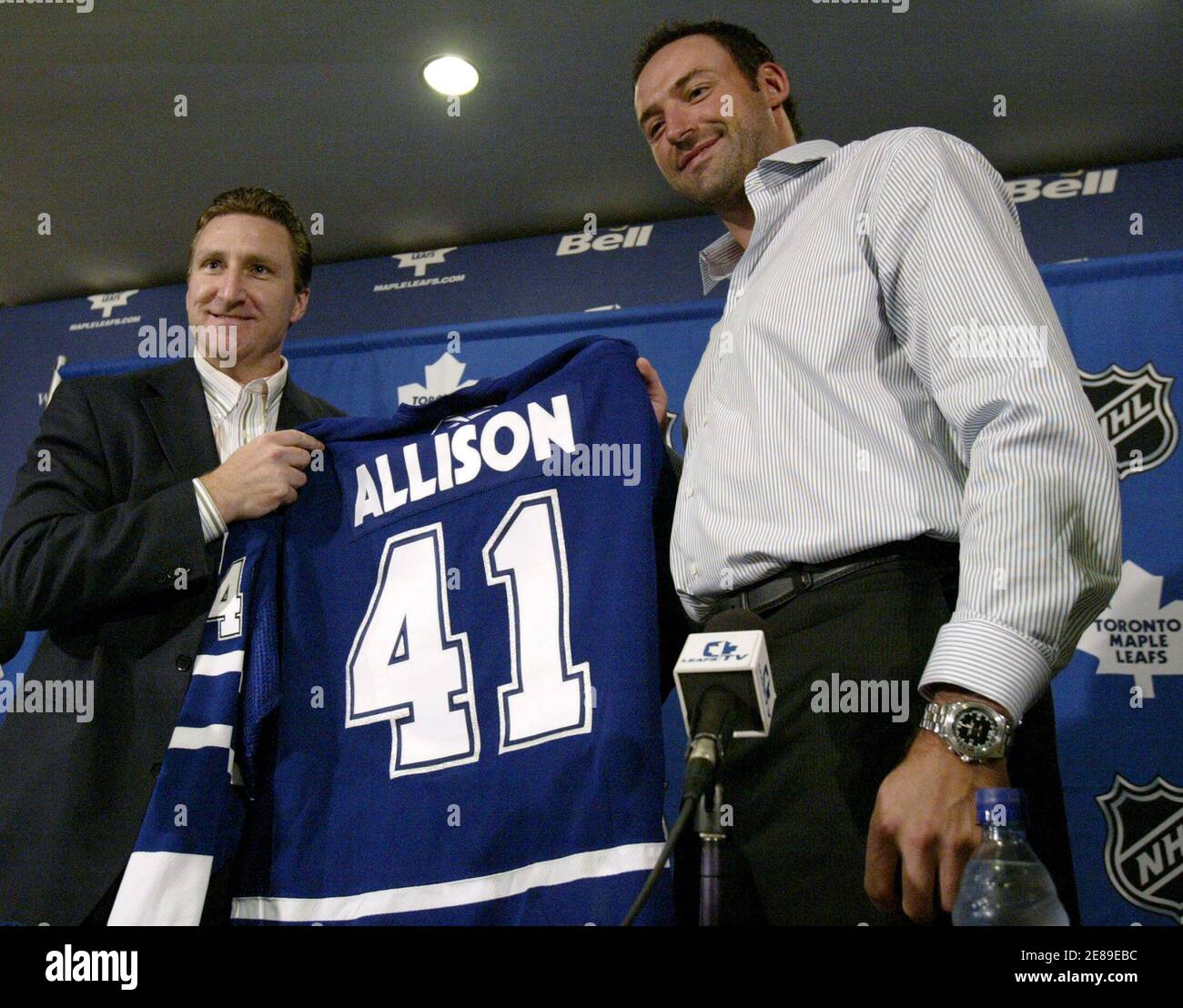 Toronto Maple Leafs general manager John Ferguson hands newly signed free  agent Jason Allison his jersey in Toronto. Toronto Maple Leafs general  manager John Ferguson (L) hands newly signed free agent Jason