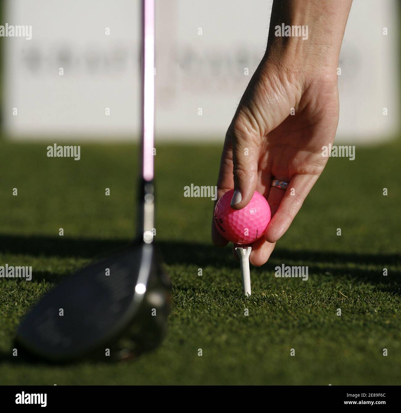 Paula Creamer places her pink Precept Tour ball on the tee at the first tee box at the Kraft Nabisco Championship golf tournament in Rancho Mirage, California April 2, 2006. For each birdie she makes with the ball, Bridgestone, the company that makes the ball, will make a donation to the LPGA/USGA Girls Golf program. REUTERS/Danny Moloshok Stock Photo