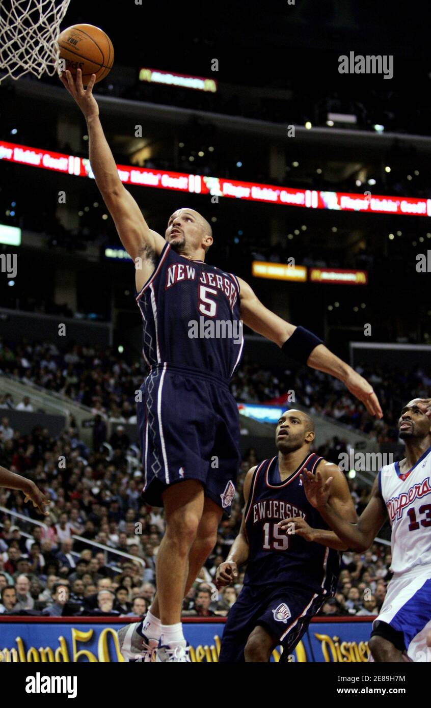 New Jersey Nets Jason Kidd (5) scores on a layup while driving the lane  against the defense of the Los Angeles Clippers Quinton Ross (R) as Nets'  Vince Carter (C) looks on