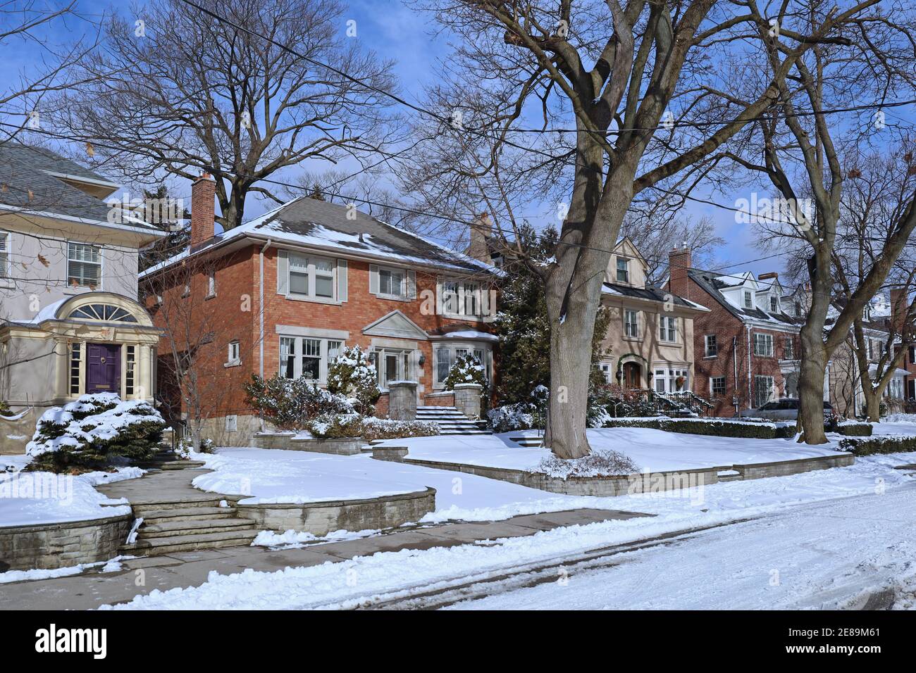 Street of traditional middle class single family houses on a sunny day in winter Stock Photo