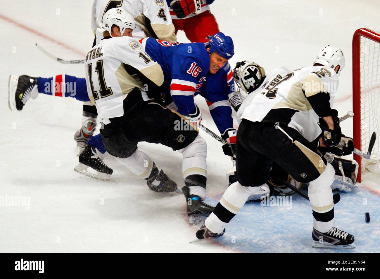 New York Rangers' Sean Avery (C-#16) dives towards the puck in front of the Pittsburgh Penquins goal in the second period of Game 3 of their NHL Eastern Conference semi-finals series in New York in this file photo April 29, 2008. The Rangers announced on April 30, 2008 that Avery suffered a lacerated spleen in Tuesday night's game and will be sidelined for the remainder of the season. At left is Penguins' Jordan Staal and at right is Penguins'Hal Gill.  REUTERS/Mike Segar/Files  (UNITED STATES) Stock Photo