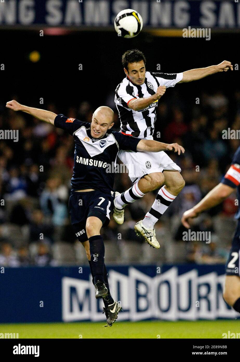 Juventus's Marco Marchionni (R) heads the ball past Melbourne Victory's Matthew Kemp to score a goal during their friendly soccer match in Melbourne May 30, 2008.    REUTERS/Mick Tsikas        (AUSTRALIA) Stock Photo