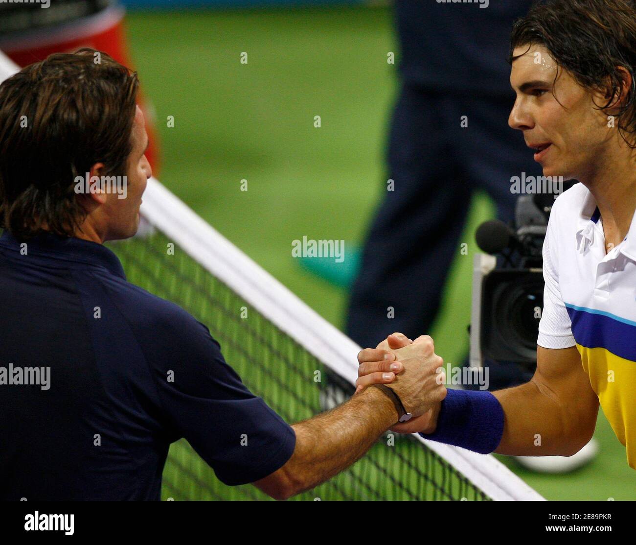 Spain's Rafael Nadal (R) shakes hands with Fabrice Santoro of France