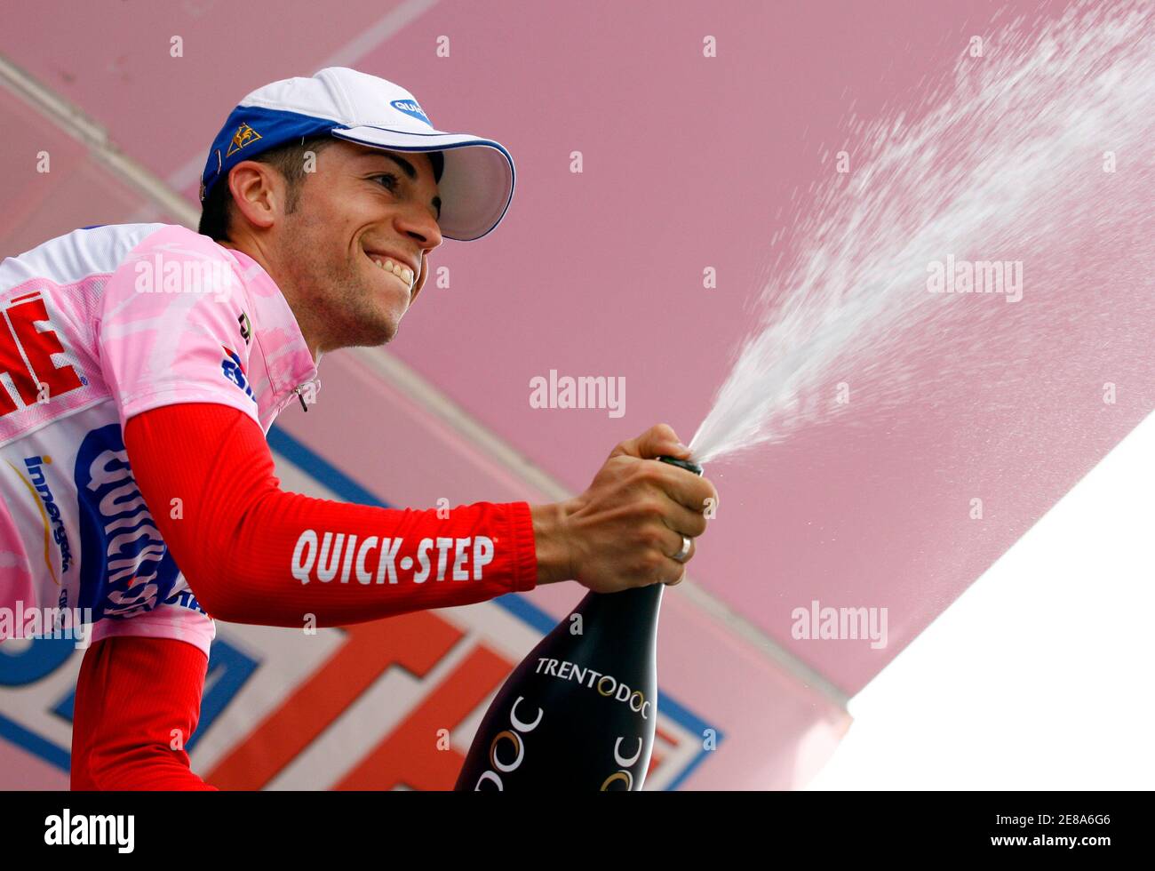 Italy's Giovanni Visconti, wearing the leader's pink jersey, celebrates on the podium with a bottle of sparkling wine after the seventh stage of the 176-km Giro d'Italia cycling race from Vasto to Pescocostanzo May 16, 2008.  REUTERS/Giampiero Sposito (ITALY) Stock Photo