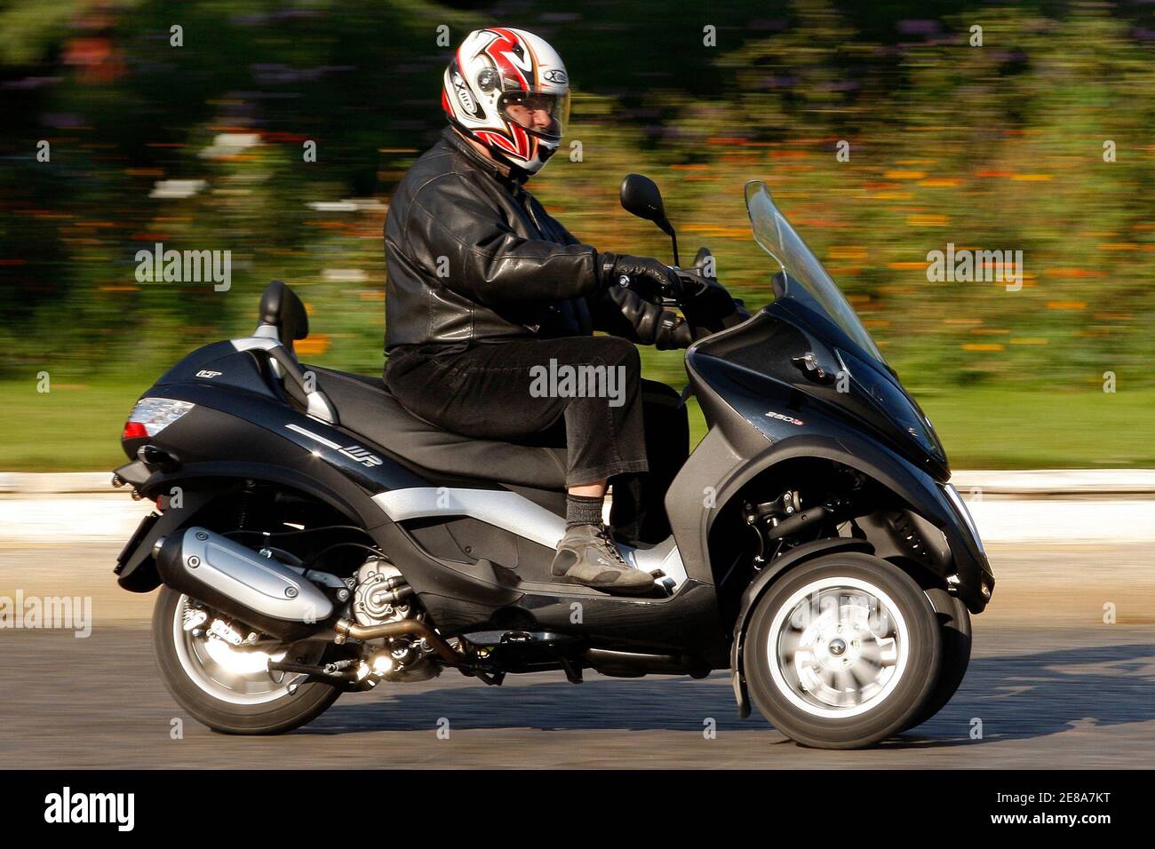 A member of the media rides the new scooter Piaggio MP3 in Paris September  26, 2008. The Piaggio MP3 will be available soon in a special 250cc and 400  cc configuration for