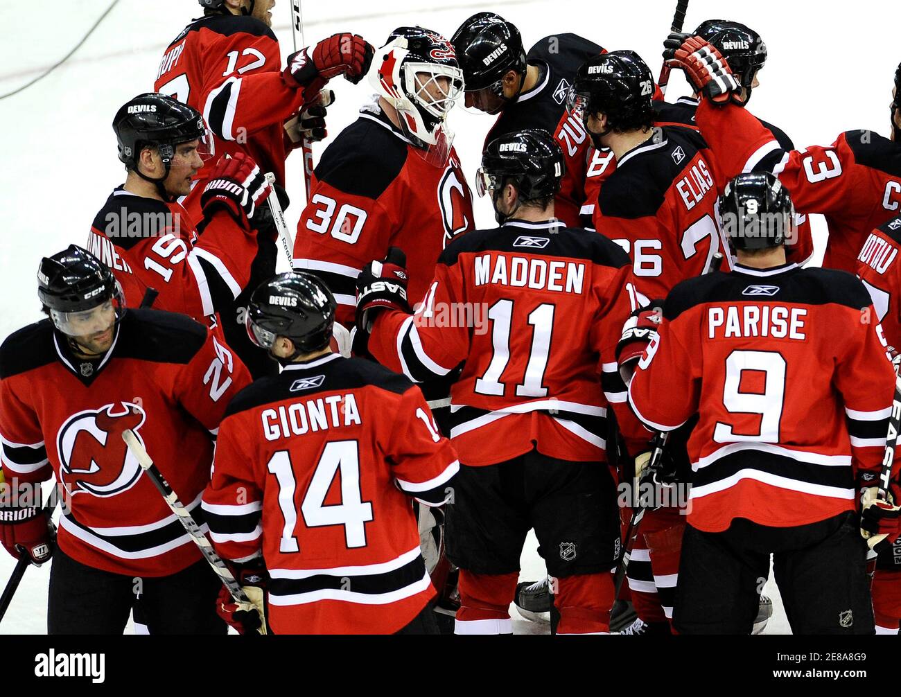 New Jersey Devils surround goaltender Martin Brodeur after their win over  the Carolina Hurricanes in Game 1 of the NHL Eastern Conference  quarterfinal hockey playoffs in Newark, New Jersey, April 15, 2009.