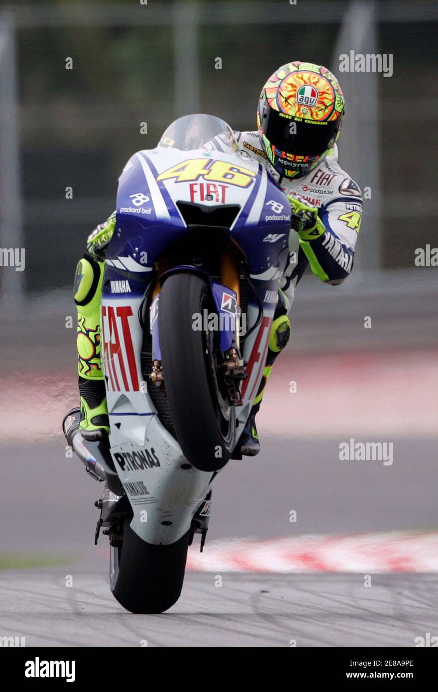 Yamaha MotoGP rider Valentino Rossi of Italy pulls a wheelie during a practice session at the Sepang International Circuit near Kuala Lumpur October 23, 2009. The Malaysian Motorcycle Grand Prix will be Yamaha MotoGP rider Valentino Rossi of Italy pulls a wheelie during a practice session at the Sepang International Circuit near Kuala Lumpur October 23, 2009. The Malaysian Motorcycle Grand Prix will be