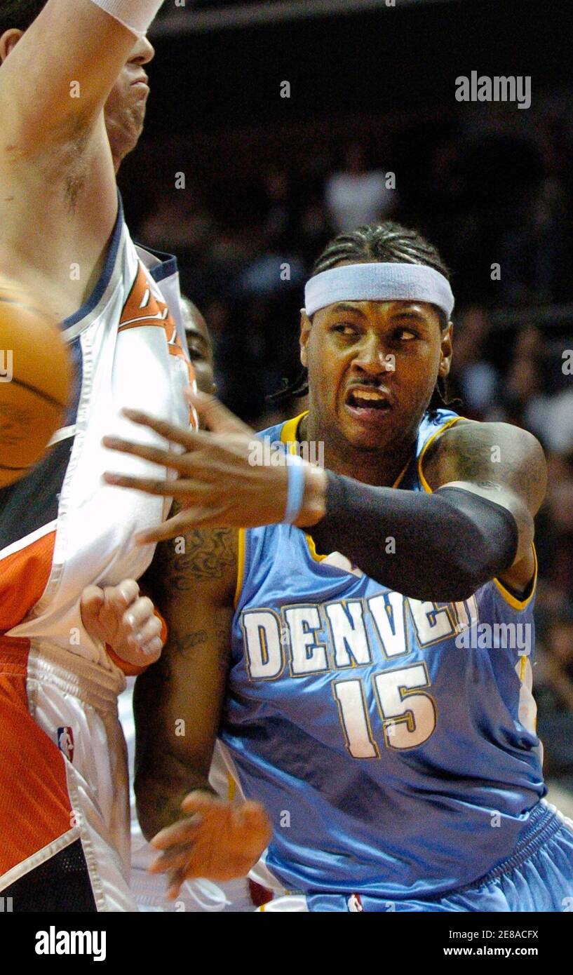 Denver Nuggets guard Carmelo Anthony (L) passes the ball under pressure  from Charlotte Bobcats center Primoz Brezec in Charlotte, North Carolina  December 13, 2005. REUTERS/Robert Padgett Stock Photo - Alamy
