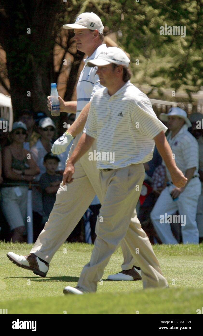 Tim Clark (R) of South Africa walk with compatriot Ernie Els at the 7th hole during the third round of the $4 million Sun City Golf Challenge in Sun City, west of Johannesburg, in South Africa December 3, 2005. REUTERS/Juda Ngwenya Stock Photo