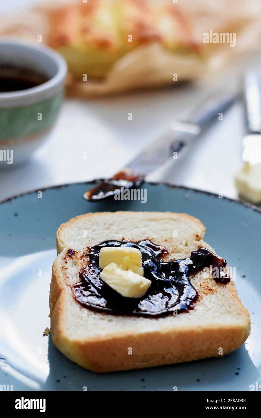 Delicious toasted bread whit cup of coffee served for breakfast/ Bread toast whit fruit jam/marmalade and butter Stock Photo