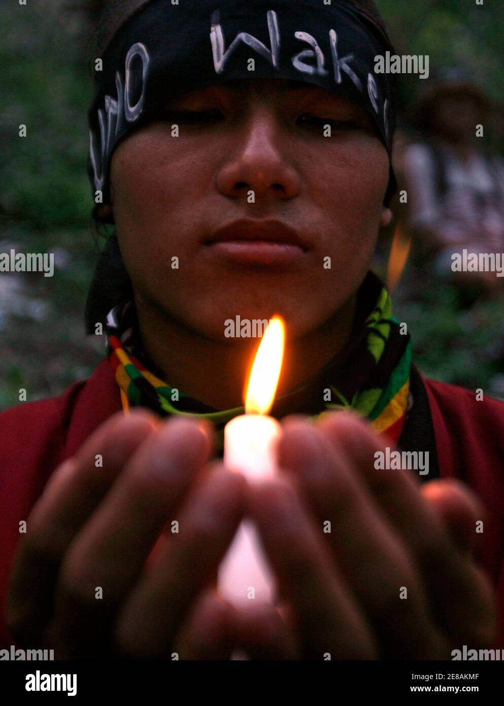 A Tibetan refugee takes part in a candle light vigil, after Indian police stopped a peace rally on its way to the Indo-China border at Nathula, at Rangopo village, about 80 km (50 miles) north of the northeastern Indian city of Siliguri March 24, 2008. REUTERS/Rupak De Chowdhuri (INDIA) Stock Photo